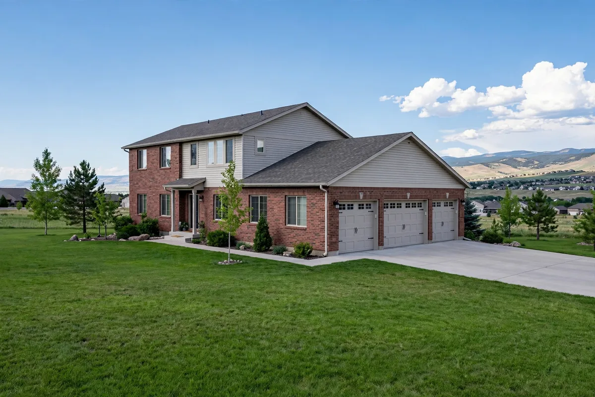 Two-story brick and siding home in Centennial with a three-car garage and a wide green lawn