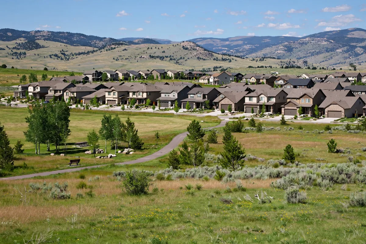 Highlands Ranch homes beside a walking trail and open space with foothills behind them